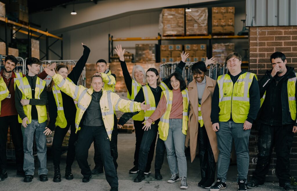 Group photo of EMERGE staff in the warehouse